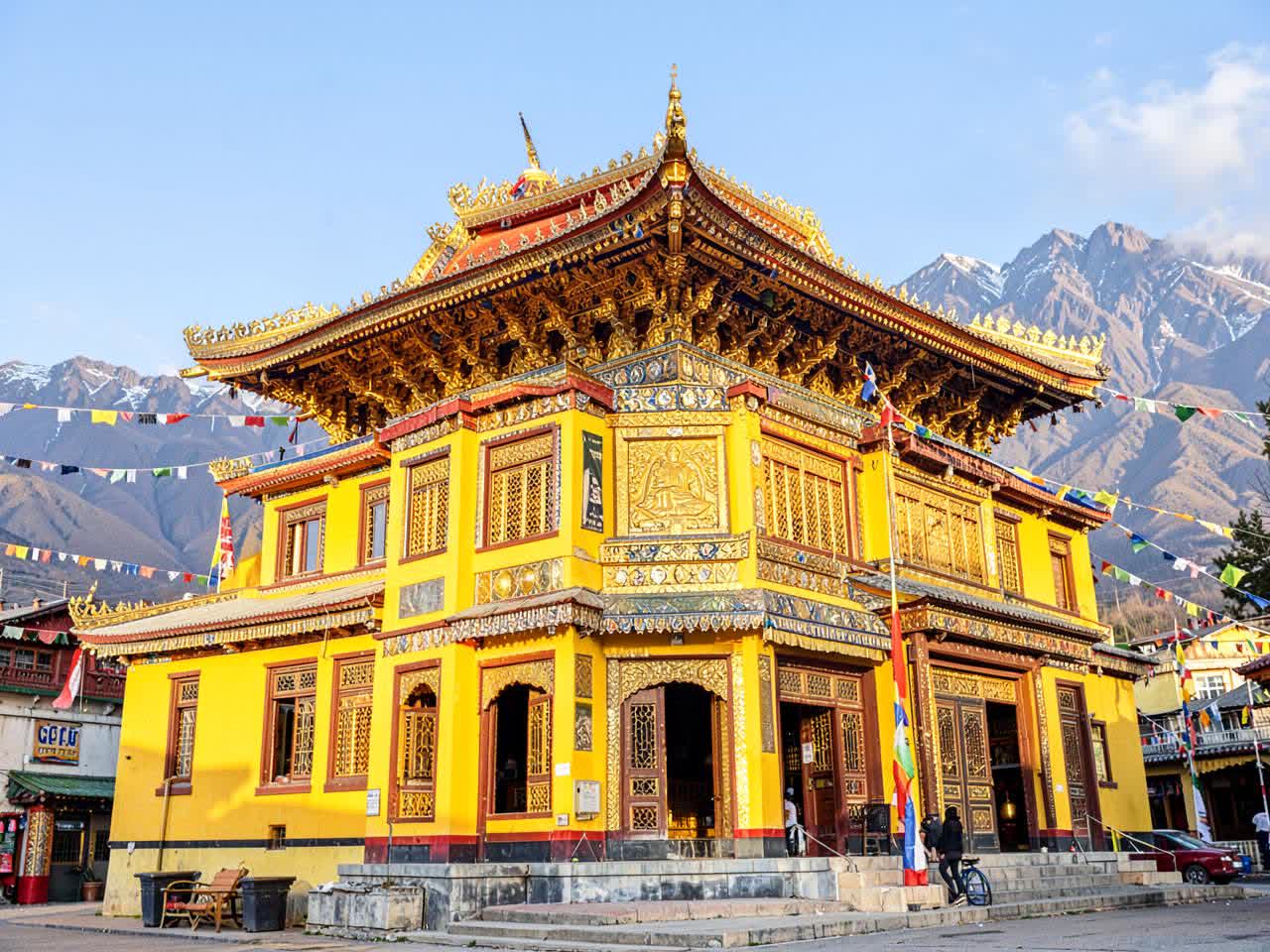 Tibetan monastery with golden roof and prayer flags in McLeod Ganj